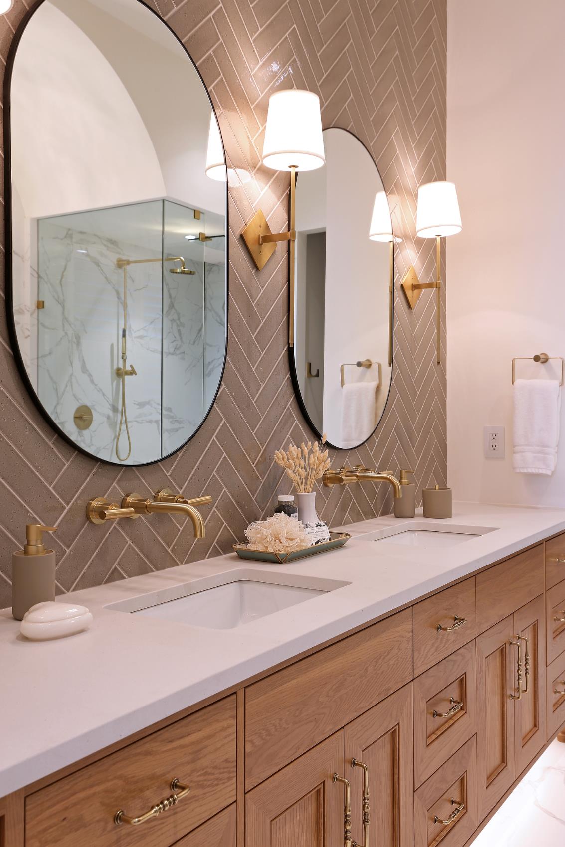 light fixtures in bathroom with tile wall and shower 